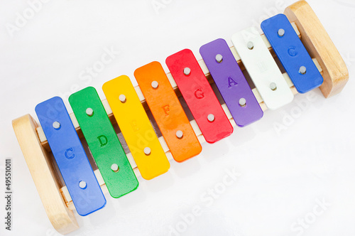 Colorful kids’ xylophone with note scale lettering on plain background with copy space