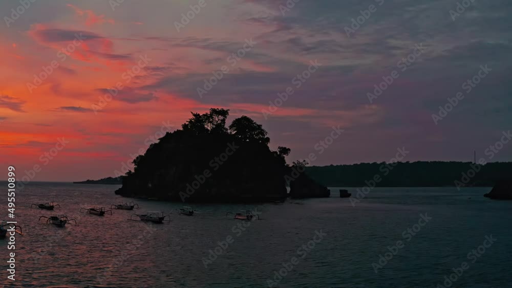 Beautiful nature landscape with scenery tropical island and fishing boat at colorful sunset Bali, Indonesia 4K Aerial view Beautiful nature landscape with scenery tropical island and fishing boat at colorful sunset Bali, Indonesia 4K Aerial view