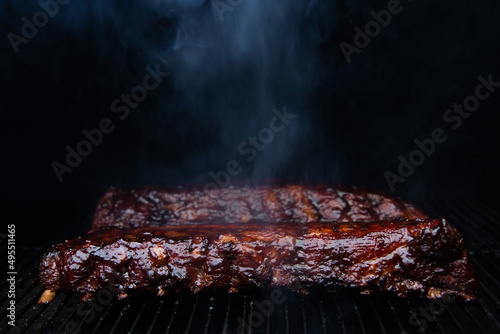 Photography Barbecue ribs cooking on smoker grill