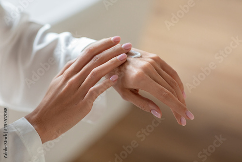 Dry Skin Remedy. Unrecognizable Young Woman Applying Hand Cream, Closeup Shot