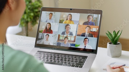 Young Asian businesswoman work at home and virtual video conference meeting with colleagues business people, online working, video call via computer laptop at home office