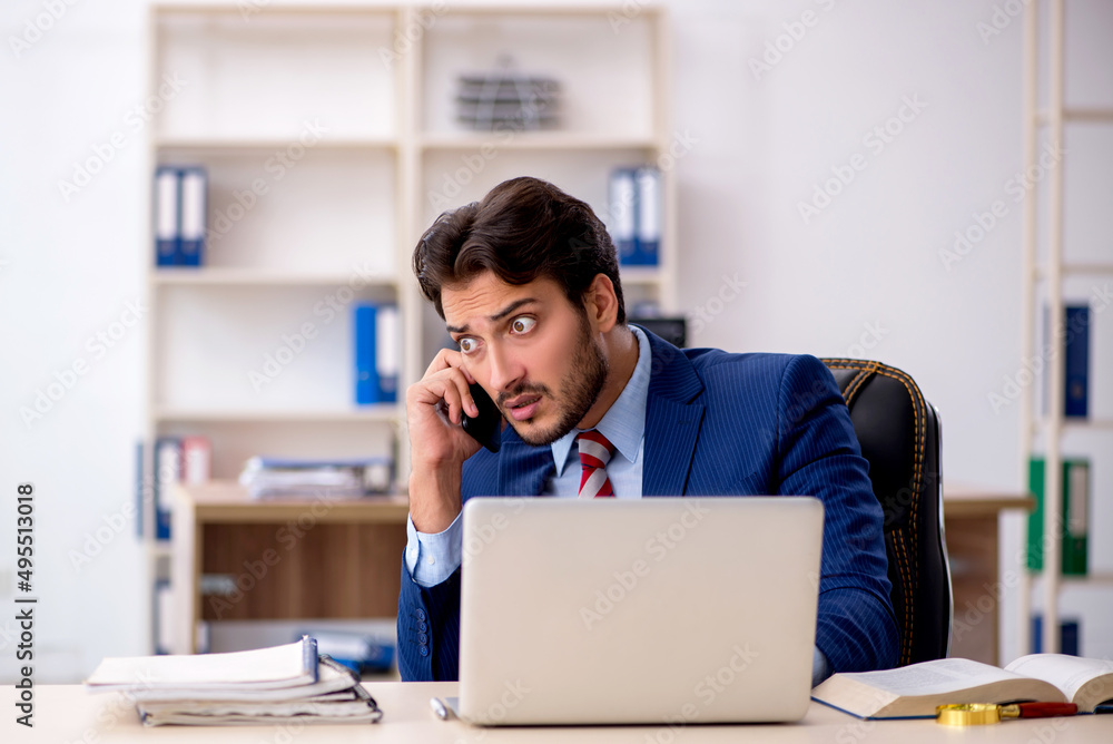 Young male employee working in the office Young male employee working in the office