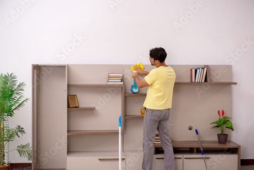 Young man doing housework at home