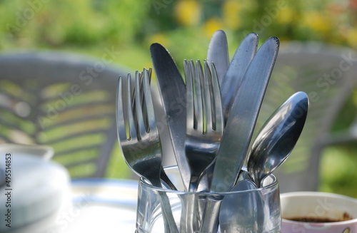 Obraz na plátně Metal cutlery in a glass