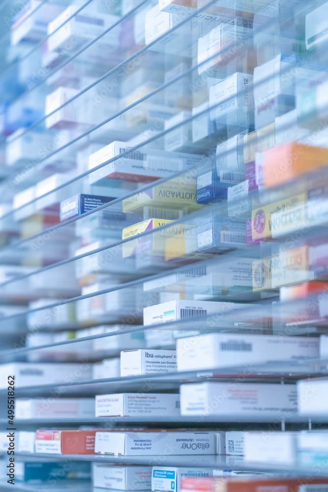 A pharmacy storage room ,Drugs are arranging and stored on a glass shelf in a pharmacy.taken out