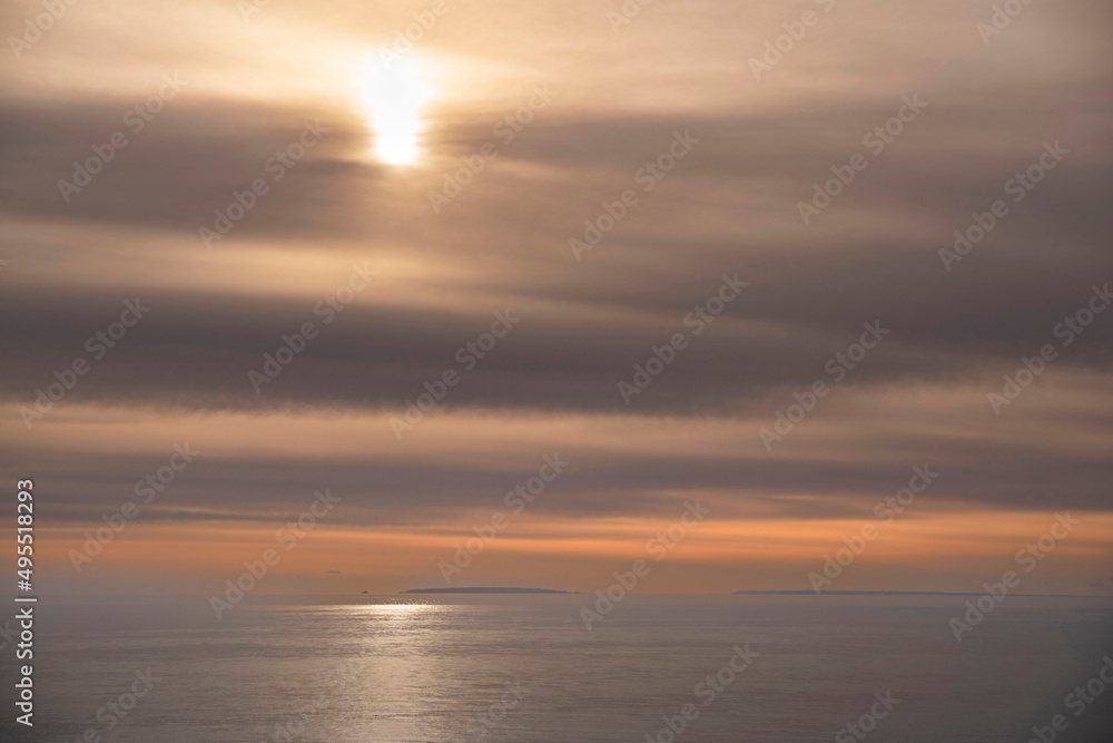 Sunset on the sea with a cloudy sky