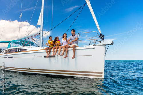 Happy Hispanic family relaxing together on private yacht © Spotmatik