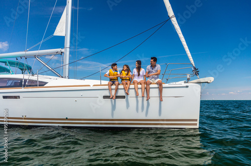 Latin American family relaxing together on luxury yacht © Spotmatik