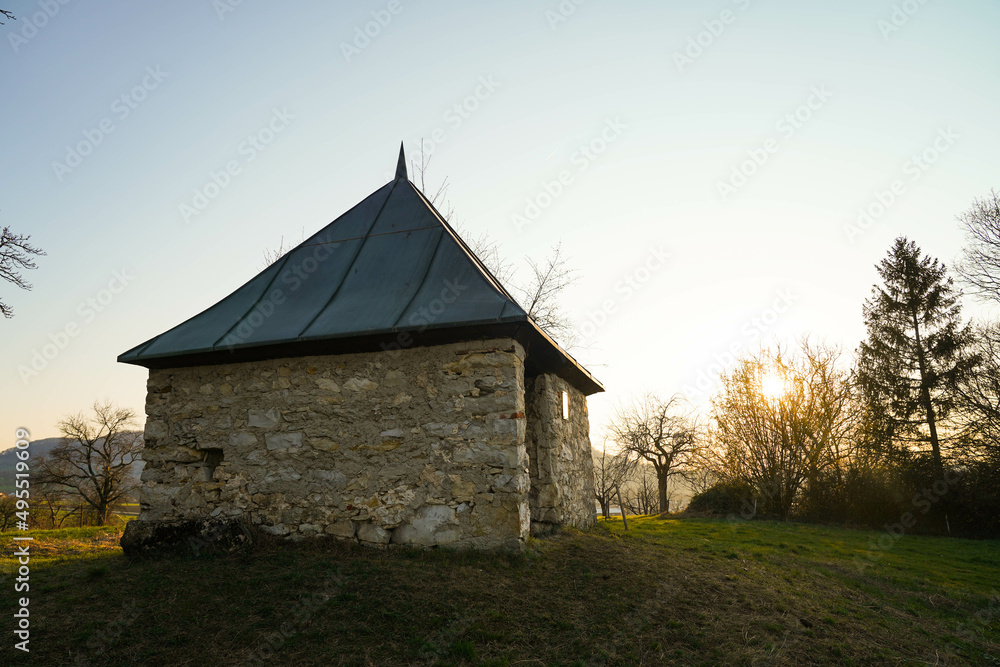 Fototapeta premium little shelter hut surrounded by trees before sunset in germany near stuttgart