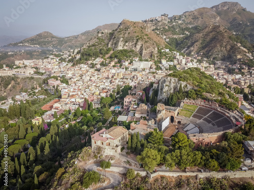 Aerial drone. The ancient Greek theatre and town of Taormina, Sicily, Italy.