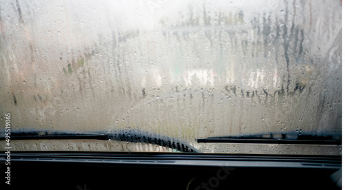 close-up view of sweaty car with dew all over windshield