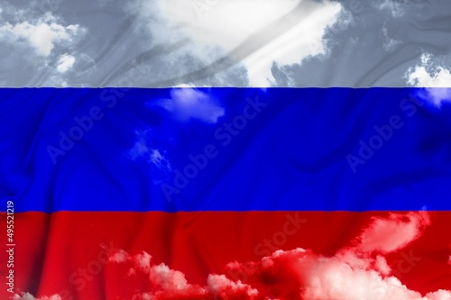 Russian tricolor flag waving in the wind against sky.