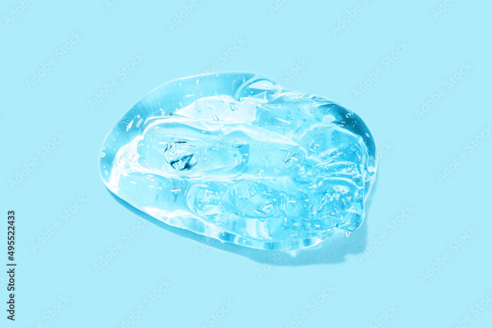 Blue transparent smear of liquid moisture serum for face. Hydrating Hyaluronic acid. Antibacterial gel. Cosmetic products for makeup and skin care. Cosmetology. Blue transparent smear of liquid moisture serum for face. Hydrating Hyaluronic acid. Antibacterial gel. Cosmetic products for makeup and skin care. Cosmetology.