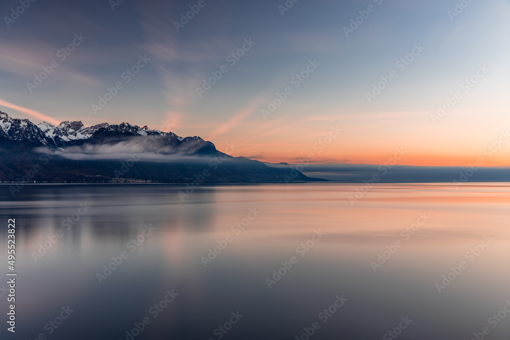 Reflex of the sky during beatiful sunset by the lake with the Alps in the background at Montreux Switzerland