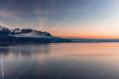 Fototapeta Naklejka Na Ścianę i Meble -  Reflex of the sky during beatiful sunset by the lake with the Alps in the background at Montreux Switzerland