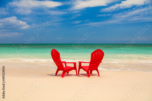 Fototapeta Naklejka Na Ścianę i Meble -  Tropical island with red chairs on sandy beach