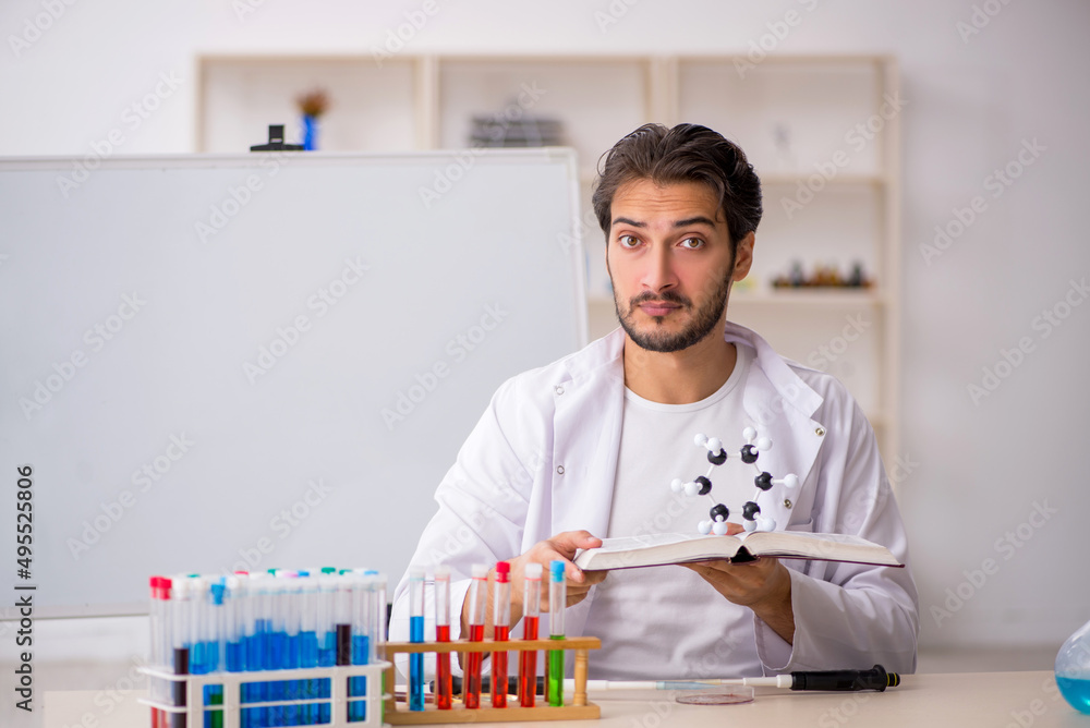 Young male chemist working at the lab Young male chemist working at the lab