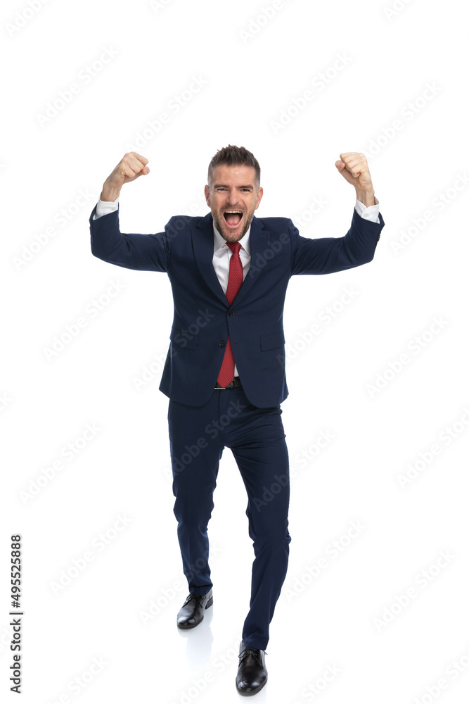 young businessman celebrating the victory with his arms up young businessman celebrating the victory with his arms up