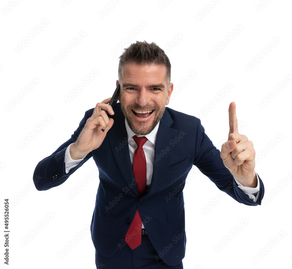 businessman pointing up while talking on the phone businessman pointing up while talking on the phone