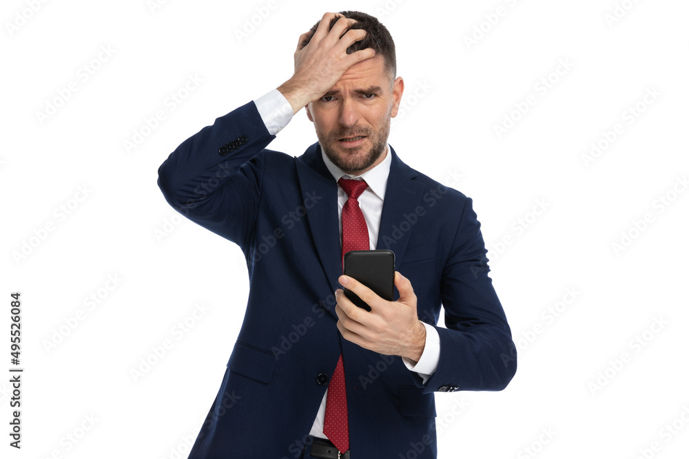 businessman slapping his head seeing what text he received businessman slapping his head seeing what text he received