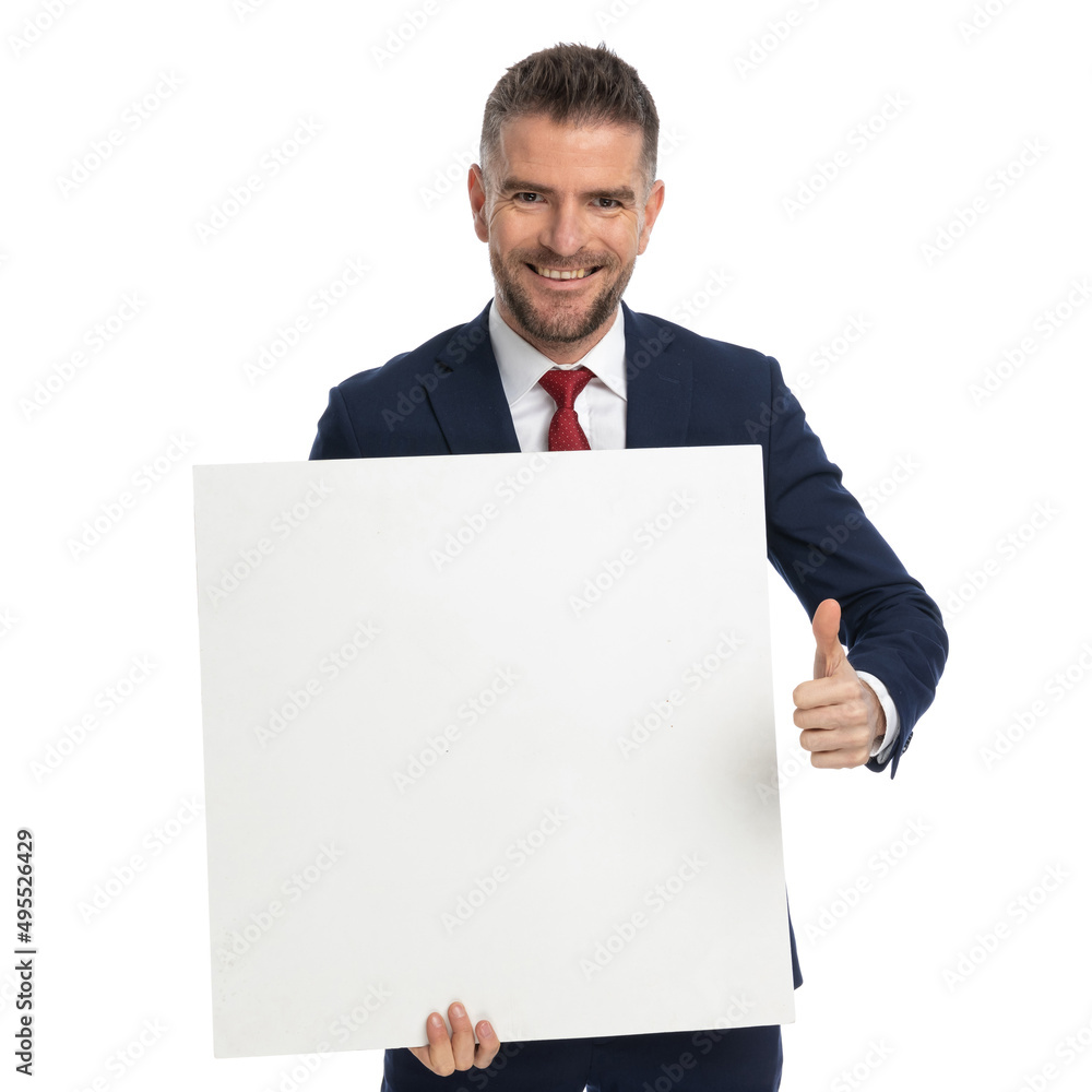 businessman giving a thumbs up while presenting a blank billboard businessman giving a thumbs up while presenting a blank billboard