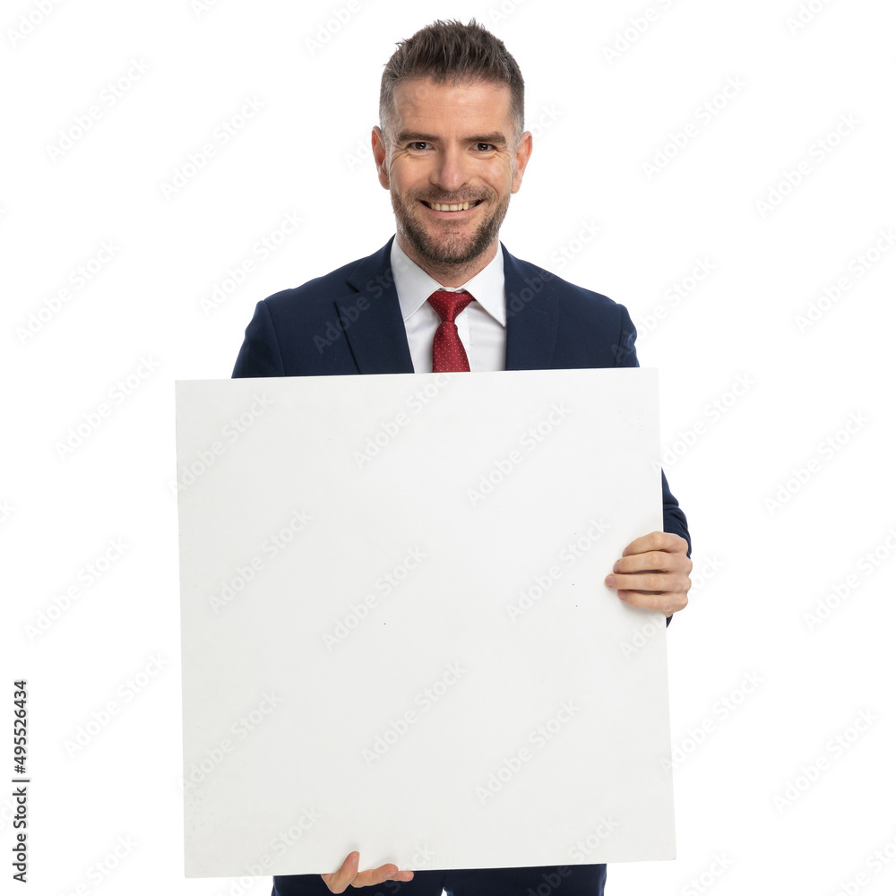 businessman presenting his blank billboard and smiling at the camera businessman presenting his blank billboard and smiling at the camera