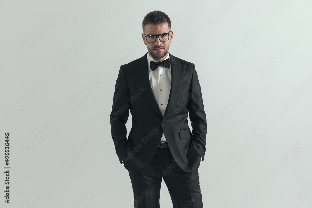 handsome businessman holding hands in pockets and posing handsome businessman holding hands in pockets and posing