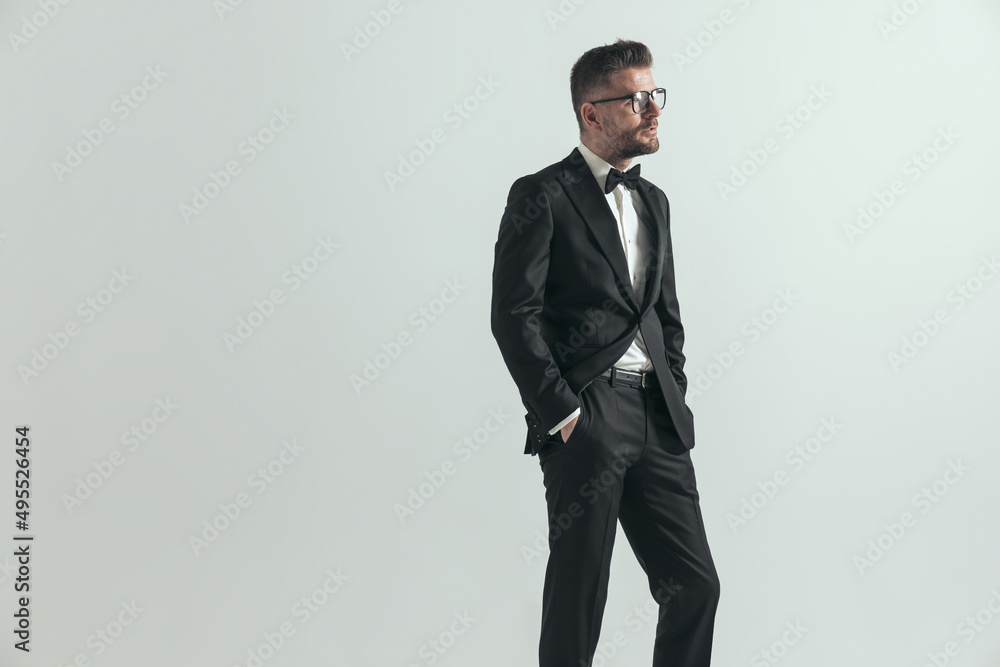 businessman in black tuxedo is looking to side businessman in black tuxedo is looking to side