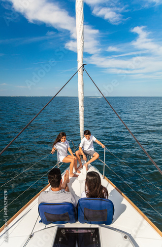 Latino family sitting on bow of luxury yacht © Spotmatik