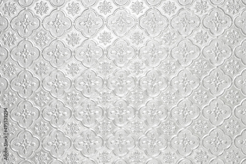 Textured pale white shiny light background with a pattern, painted glass in vintage style wall silver