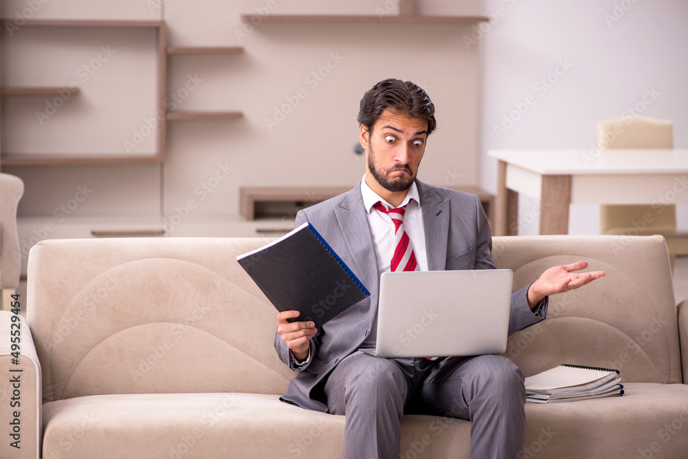 Young male employee working from home during pandemic Young male employee working from home during pandemic