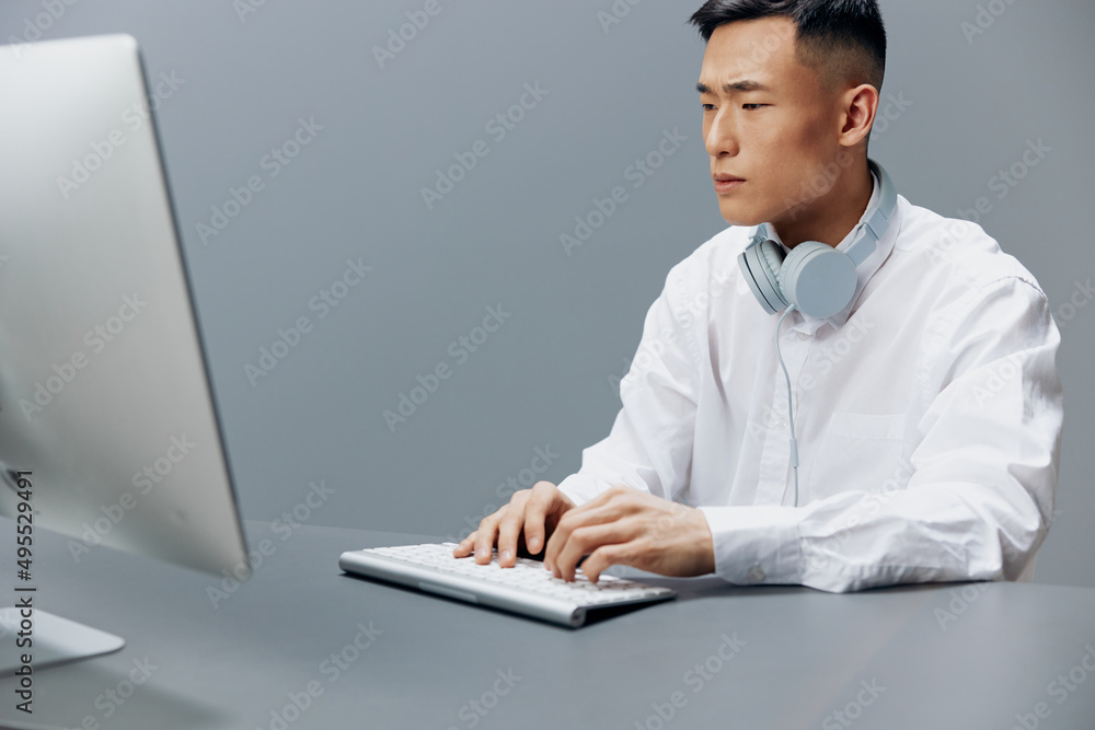 businessmen in a white shirt with headphones sits in the office Lifestyle work businessmen in a white shirt with headphones sits in the office Lifestyle work