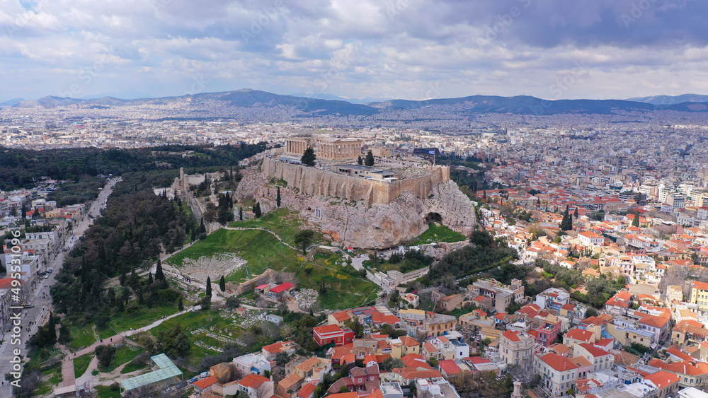 Aerial drone photo of unique Masterpiece of Ancient times the Parthenon on top of iconic Acropolis hill with cloudy sky, Athens, Attica, Greece