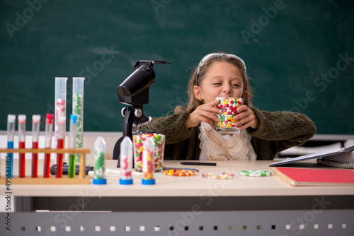 Young little girl chemist in drugs synthesis concept photo