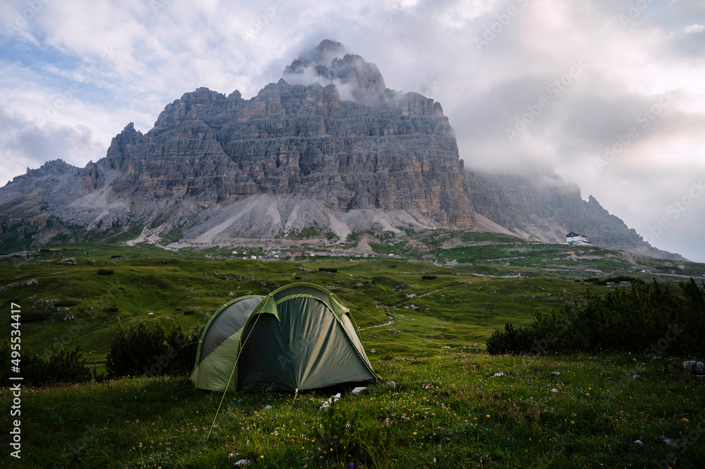 Camping with tent in Dolomites, Italy,'' Tre Cime di Lavaredo'' in background