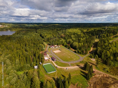 Aerial summer view of football field in forest camp
