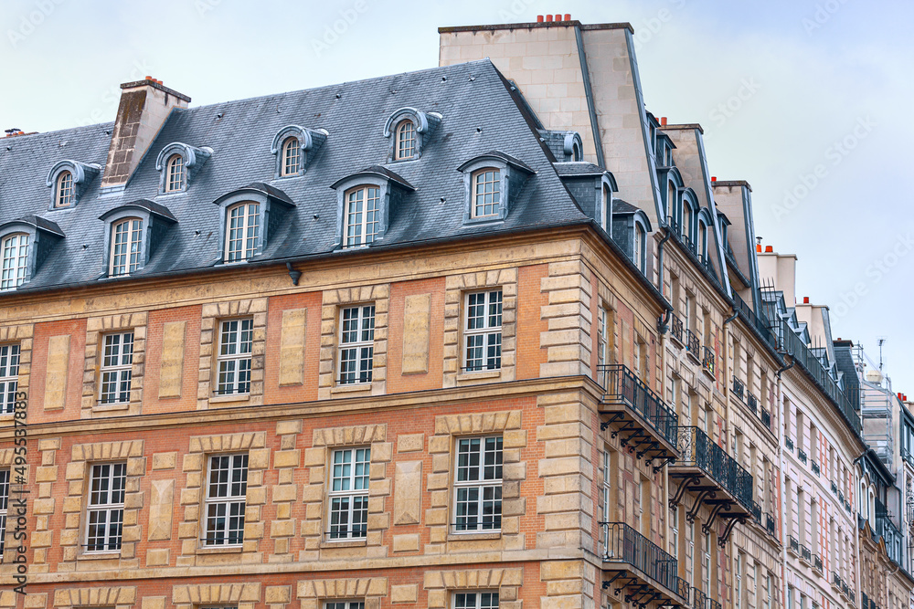 Typical residential architecture of Paris . Exterior view of house with lofts and attics in France