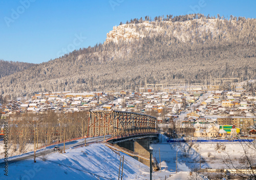 Bridge over the Lena River and the Mir rock in Ust-Kut in winter. photo