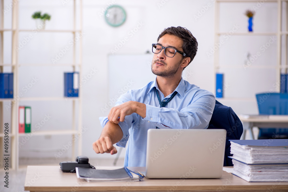 Young businessman employee and too much work in the office Young businessman employee and too much work in the office