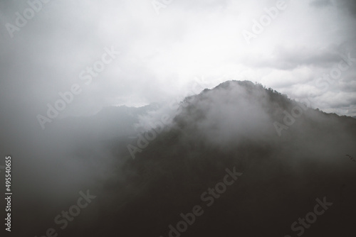 View of a dark mountain range with bright cloudy sky
