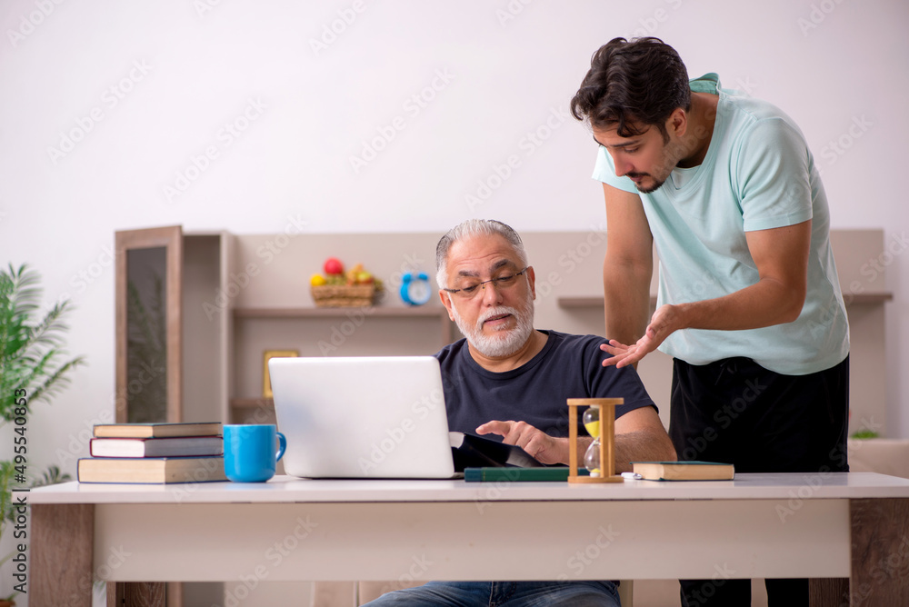 Grandfather and grandson at home with computer Grandfather and grandson at home with computer