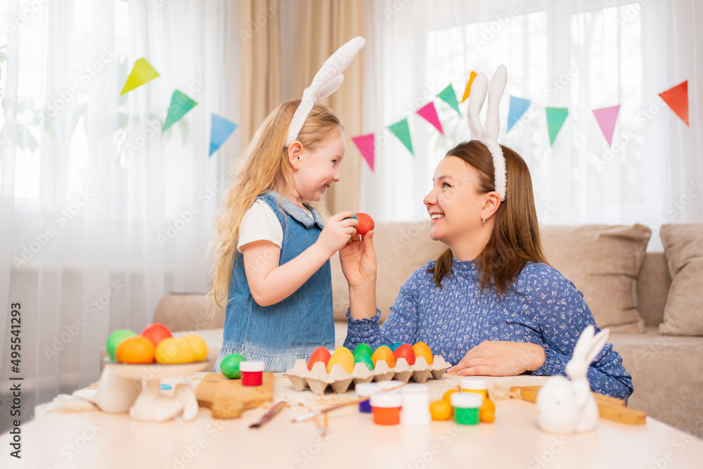 mother and sweet daughter play with Easter eggs in game of who will break. mother and sweet daughter play with Easter eggs in game of who will break.