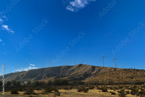 wind farm turbine hillside mountain top energy power sustainable turbines clear atmosphere landscape