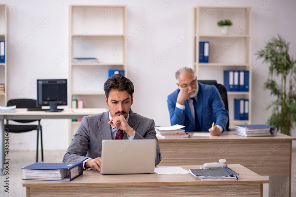 Two male colleagues working in the office Two male colleagues working in the office