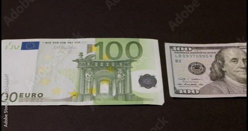 One hundred Euro banknotes on dark background. European monetary Union currency