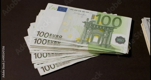 One hundred Euro banknotes on black background. Euro currency