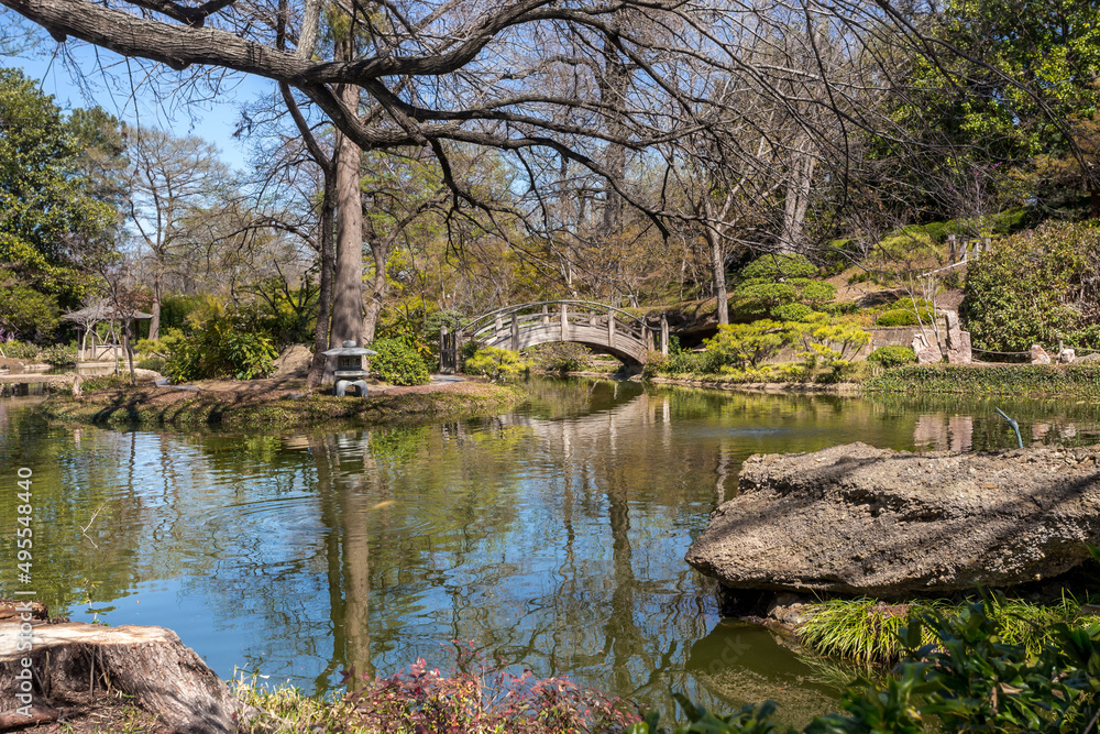 Beautiful pond reflection and a bridge over water in springtime