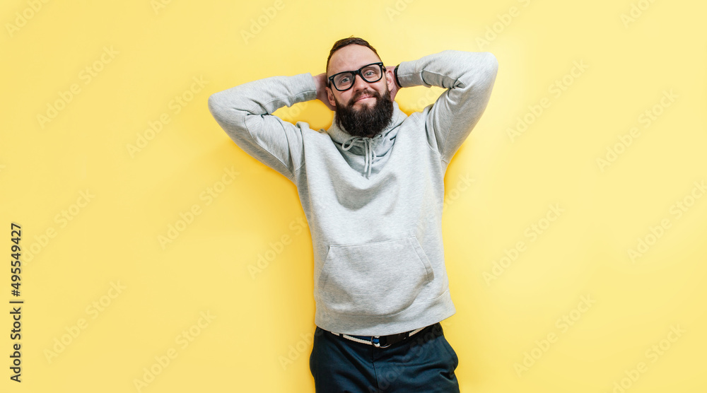 Studio portrait of handsome hipster guy with beard wearing gray blank hoodie with space for your logo or design. Mockup for print Studio portrait of handsome hipster guy with beard wearing gray blank hoodie with space for your logo or design. Mockup for print