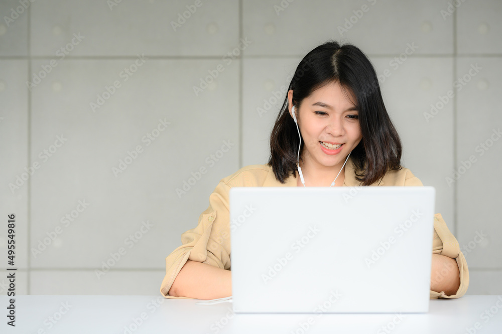 happy Asian woman video conferrence working with laptop at home in office happy Asian woman video conferrence working with laptop at home in office