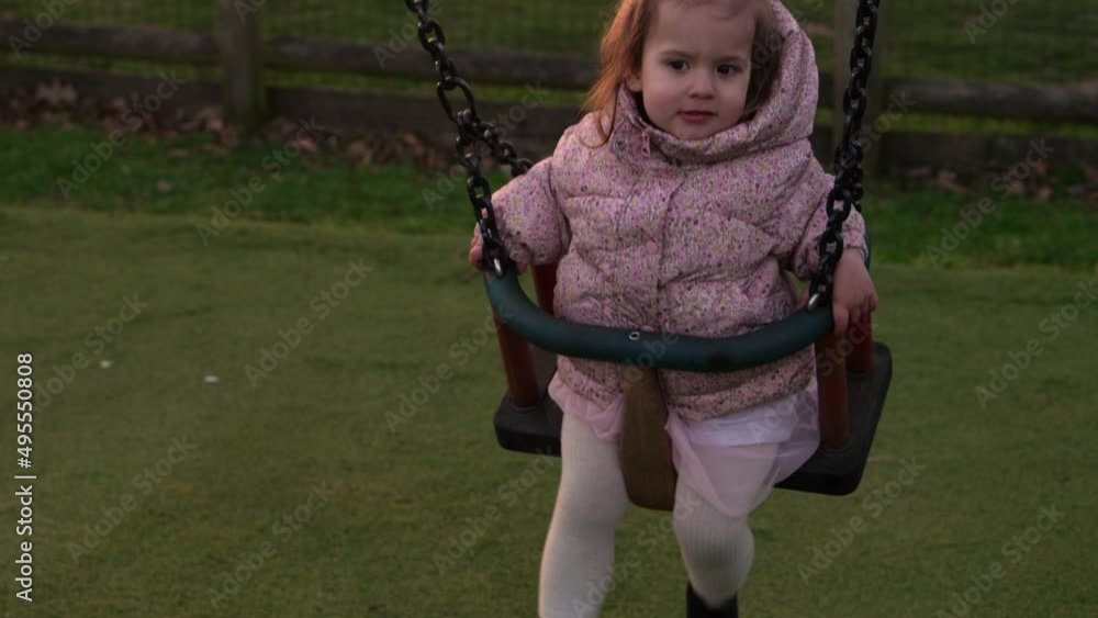 Medium Plan of Funny Little Preschool Chubby Girl In Pink Jacket Swinging On Swing Before Sunset. Baby Playing On Playground. Kids Entertainment, Childhood, Child Development, Happy Family Concept Medium Plan of Funny Little Preschool Chubby Girl In Pink Jacket Swinging On Swing Before Sunset. Baby Playing On Playground. Kids Entertainment, Childhood, Child Development, Happy Family Concept
